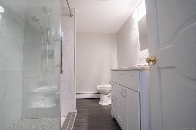 70R Tri Mountain Rd, Durham, CT 06422 - bathroom with toilet, a baseboard heating unit, vanity, a tile shower, and wood finished floors