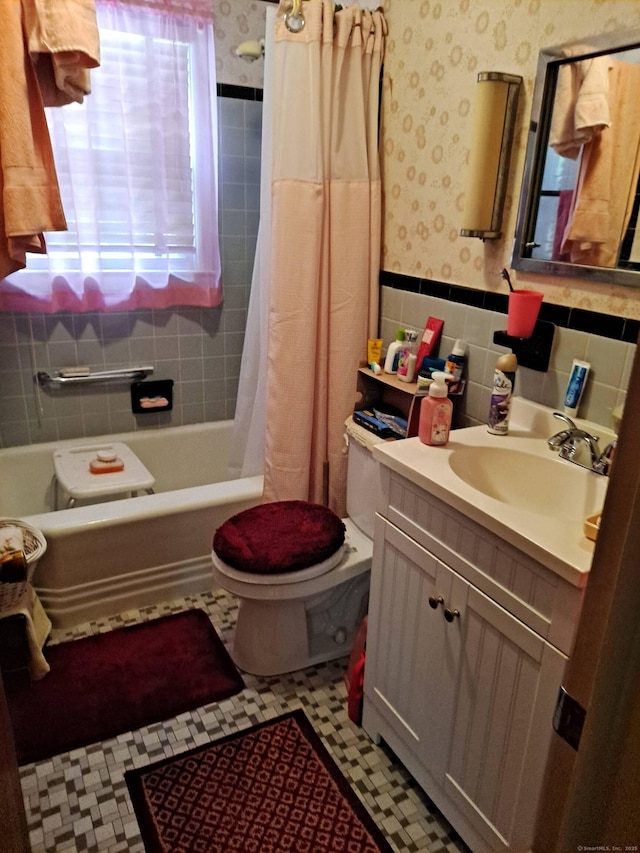 746 Hillside Ave, Hartford, CT 06106 - full bath with wallpapered walls, tile walls, toilet, vanity, and tile patterned floors