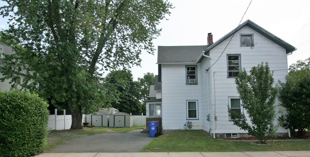72 Brooker St, Torrington, CT 06790 - view of property exterior featuring a chimney and roof with shingles