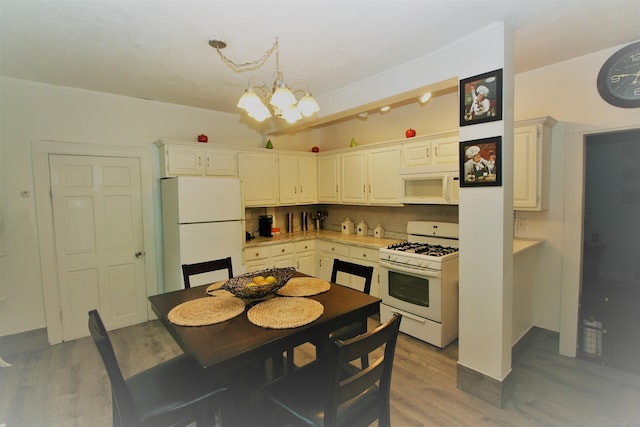 72 Brooker St, Torrington, CT 06790 - kitchen with white appliances, a chandelier, light wood-type flooring, and white cabinets