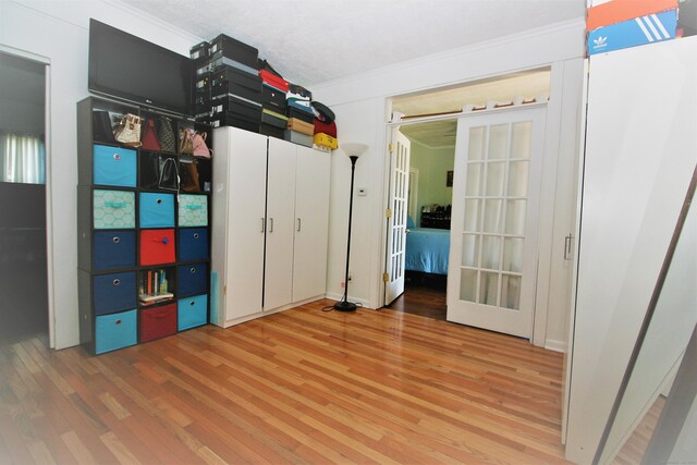 72 Brooker St, Torrington, CT 06790 - unfurnished bedroom with wood finished floors, ornamental molding, and french doors