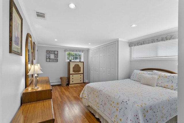 42 Woodledge Rd, Stamford, CT 06907 - bedroom featuring ornamental molding, a baseboard radiator, wood finished floors, a closet, and recessed lighting