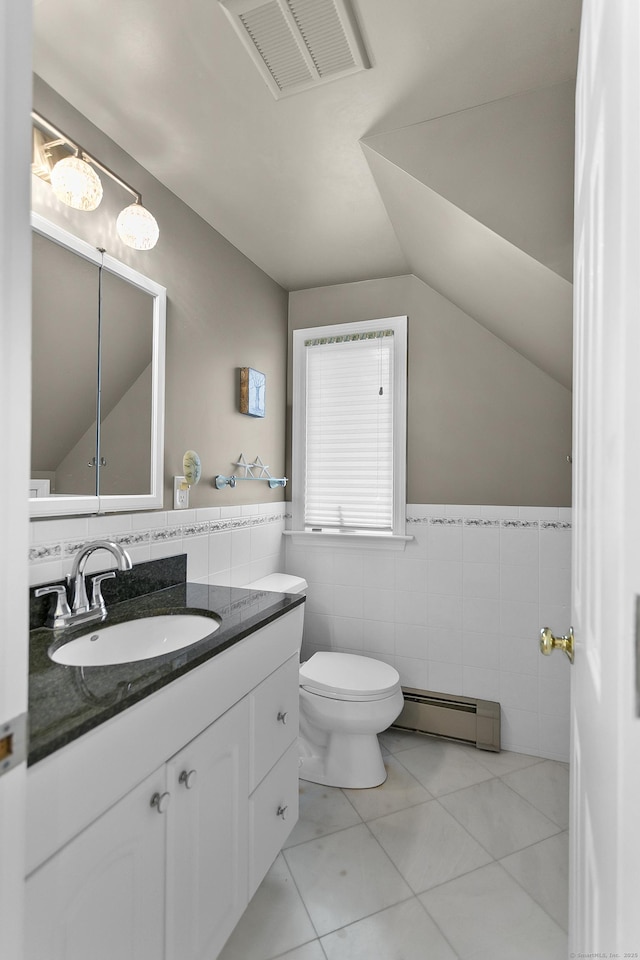 42 Woodledge Rd, Stamford, CT 06907 - half bathroom featuring baseboard heating, tile walls, vanity, lofted ceiling, and tile patterned flooring