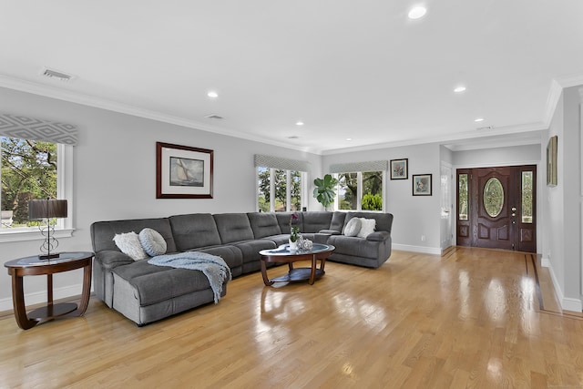 42 Woodledge Rd, Stamford, CT 06907 - living area with crown molding, healthy amount of natural light, light wood finished floors, and recessed lighting