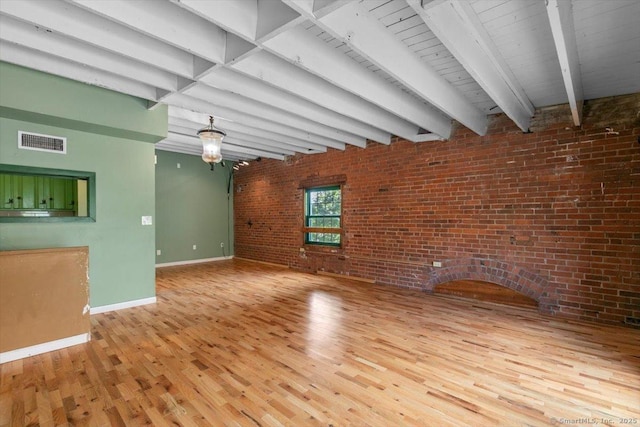 1 Front St Unit 204, New Haven, CT 06513 - unfurnished living room with baseboards, brick wall, wood finished floors, and beamed ceiling