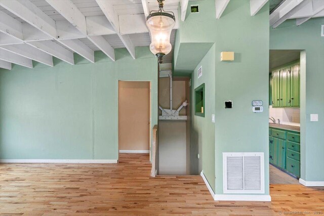 1 Front St Unit 204, New Haven, CT 06513 - empty room with beam ceiling, light wood finished floors, and baseboards