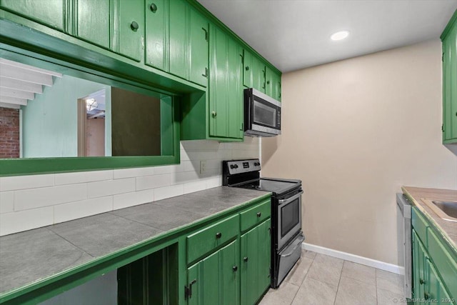 1 Front St Unit 204, New Haven, CT 06513 - kitchen featuring green cabinets, stainless steel appliances, tasteful backsplash, and recessed lighting