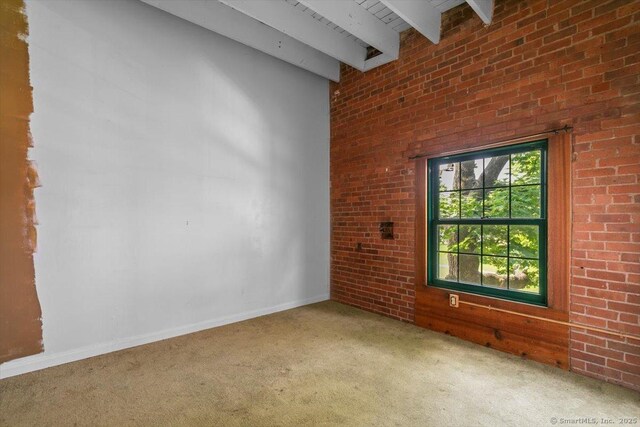 1 Front St Unit 204, New Haven, CT 06513 - empty room featuring carpet flooring, beam ceiling, baseboards, brick wall, and a high ceiling