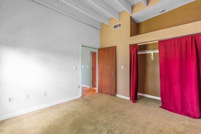 1 Front St Unit 204, New Haven, CT 06513 - unfurnished bedroom with carpet, beamed ceiling, a closet, high vaulted ceiling, and baseboards