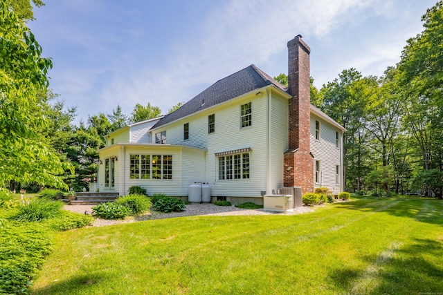 87 Falcon Crest Rd, Middlebury, CT 06762 - rear view of house with a chimney and a yard