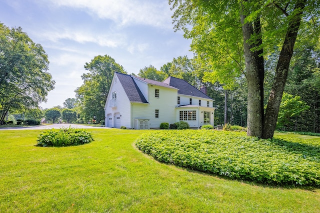 87 Falcon Crest Rd, Middlebury, CT 06762 - view of side of home with an attached garage, driveway, a yard, and a chimney