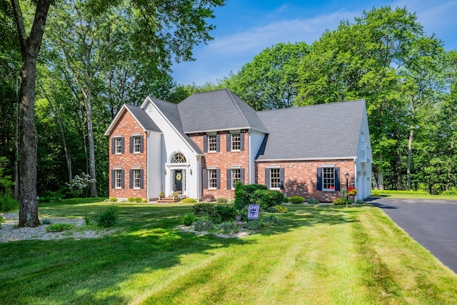 87 Falcon Crest Rd, Middlebury, CT 06762 - view of front of home featuring brick siding, asphalt driveway, a front yard, and a shingled roof