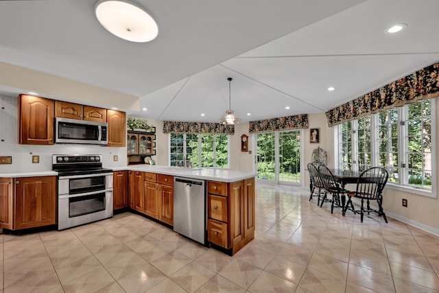 87 Falcon Crest Rd, Middlebury, CT 06762 - kitchen featuring stainless steel appliances, brown cabinetry, plenty of natural light, and recessed lighting