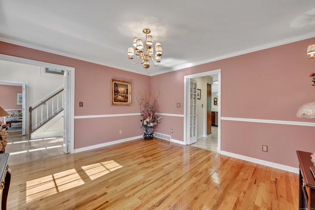 87 Falcon Crest Rd, Middlebury, CT 06762 - spare room with a chandelier, stairway, light wood-style flooring, and ornamental molding