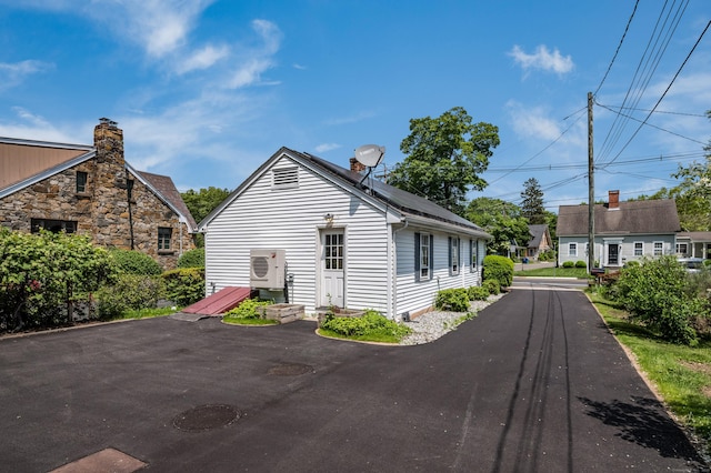 36 State St, Guilford, CT 06437 - view of side of home with ac unit and a chimney