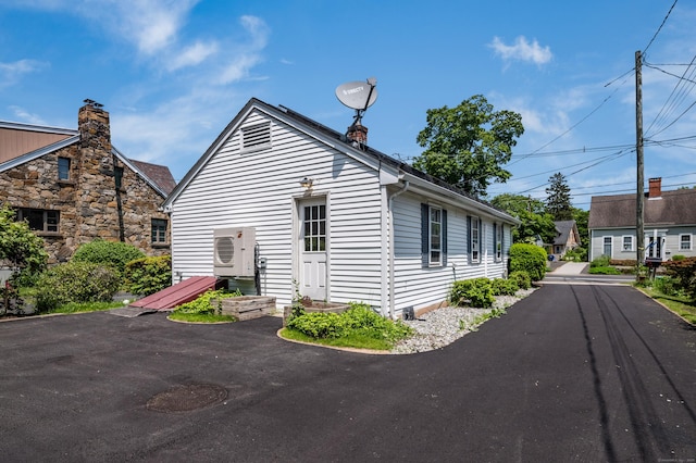36 State St, Guilford, CT 06437 - view of home's exterior with a cooling unit and a chimney