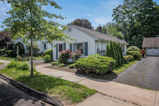 36 State St, Guilford, CT 06437 - view of front of property with a chimney, a garage, and an outdoor structure