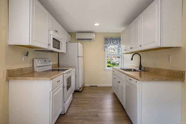 36 State St, Guilford, CT 06437 - kitchen with a sink, white appliances, an AC wall unit, white cabinetry, and recessed lighting