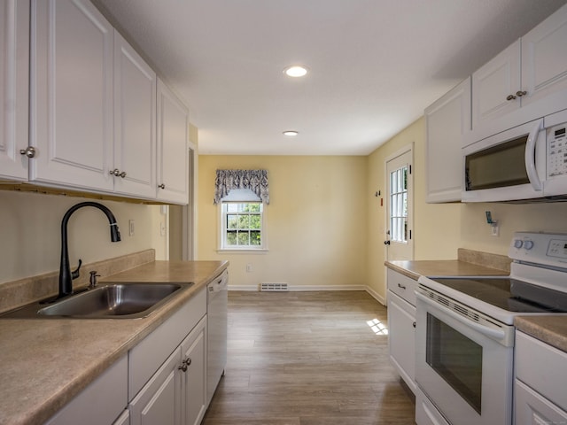 36 State St, Guilford, CT 06437 - kitchen with white appliances, a sink, white cabinets, recessed lighting, and baseboards