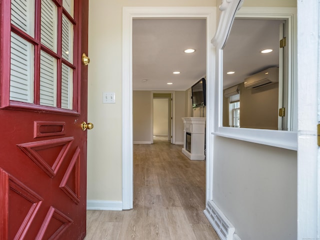 36 State St, Guilford, CT 06437 - foyer featuring an AC wall unit, wood finished floors, baseboards, a fireplace, and recessed lighting