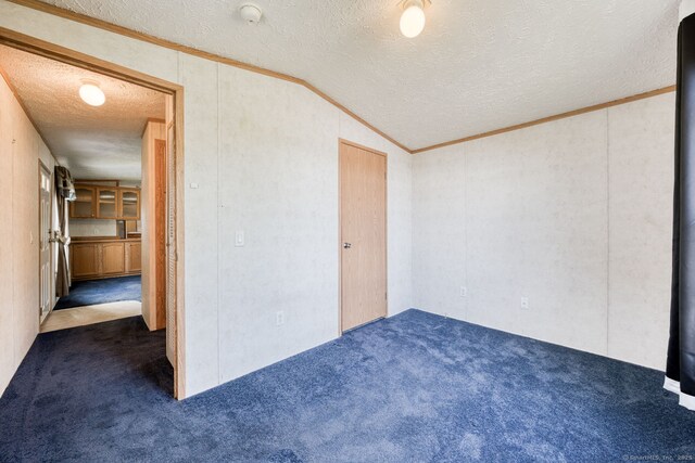 107 Lions Way, Windham, CT 06256 - carpeted empty room featuring a textured ceiling, a smoke detector, vaulted ceiling, and crown molding