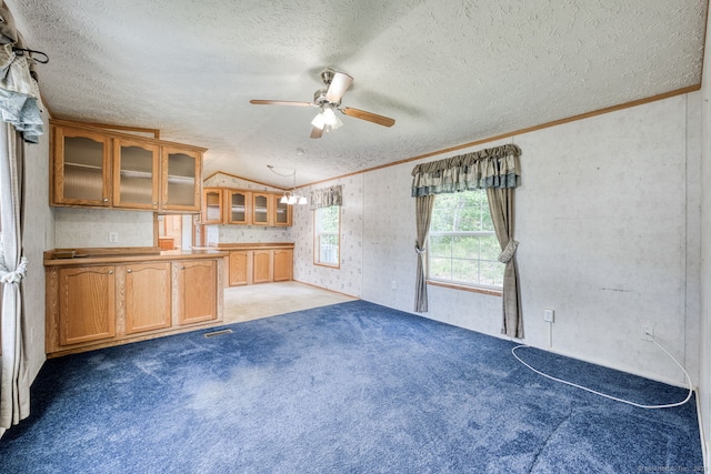 107 Lions Way, Windham, CT 06256 - unfurnished living room with a ceiling fan, lofted ceiling, a textured ceiling, carpet floors, and crown molding