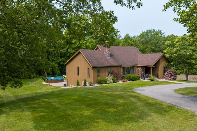 64 Attawanhood Trl, Hebron, CT 06231 - view of front of property with a chimney, a front yard, and asphalt driveway