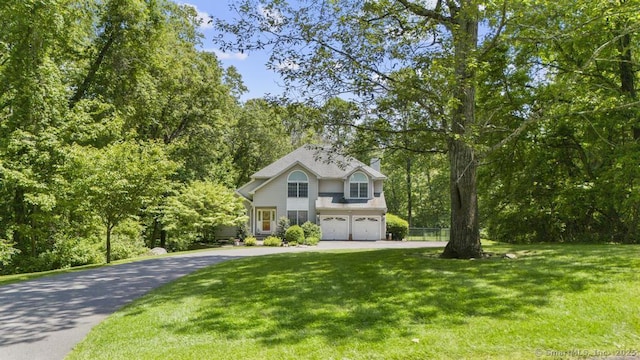 17 Raven Crest Dr, Bethel, CT 06801 - traditional-style home featuring asphalt driveway, an attached garage, and a front lawn