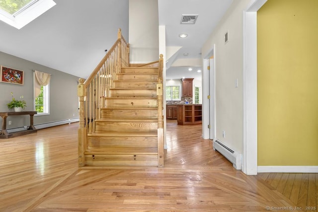 17 Raven Crest Dr, Bethel, CT 06801 - stairway featuring a baseboard heating unit, a skylight, baseboards, and wood finished floors