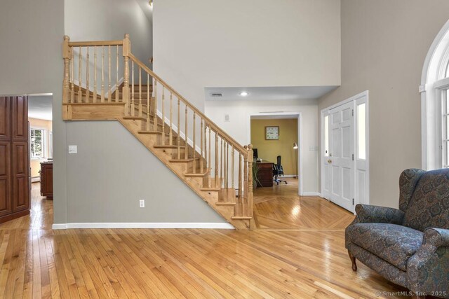 17 Raven Crest Dr, Bethel, CT 06801 - entryway featuring a high ceiling, stairs, baseboards, and light wood-style flooring