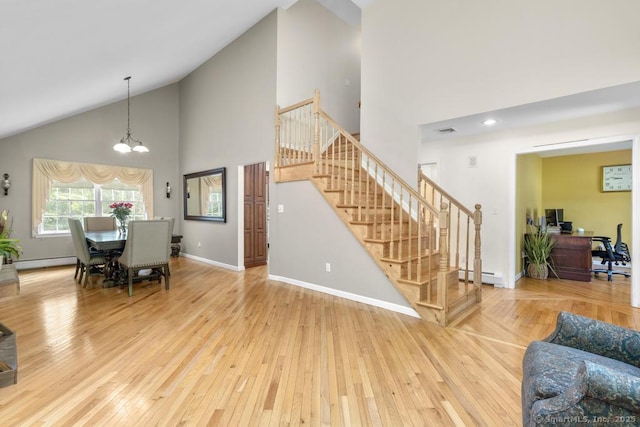 17 Raven Crest Dr, Bethel, CT 06801 - living area featuring a baseboard radiator, high vaulted ceiling, stairway, and hardwood / wood-style flooring