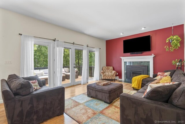 17 Raven Crest Dr, Bethel, CT 06801 - living area with french doors, a fireplace with flush hearth, light wood-type flooring, and recessed lighting