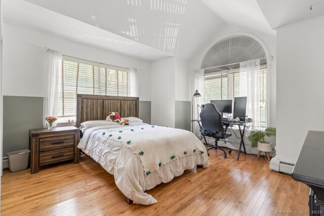 17 Raven Crest Dr, Bethel, CT 06801 - bedroom featuring light wood-style flooring, lofted ceiling, a baseboard heating unit, and an office area