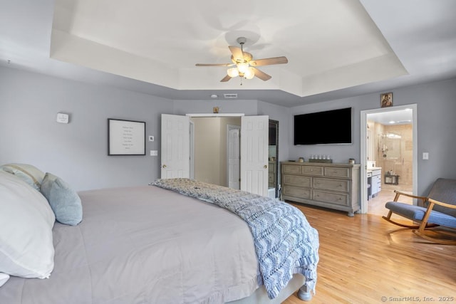 17 Raven Crest Dr, Bethel, CT 06801 - bedroom featuring a tray ceiling, light wood-type flooring, a ceiling fan, and ensuite bathroom