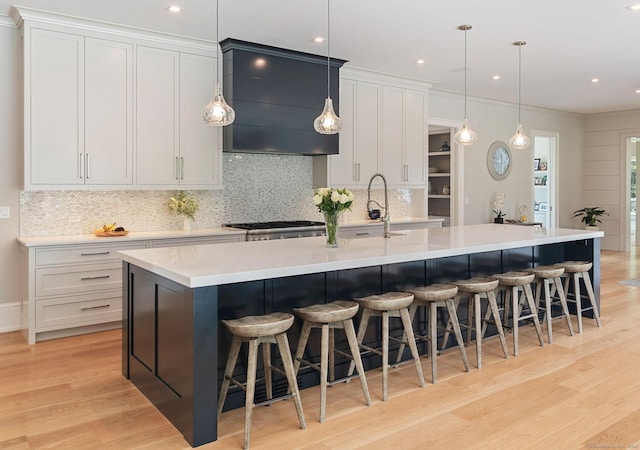 300 Hollow Tree Ridge Rd, Darien, CT 06820 - kitchen with extractor fan, tasteful backsplash, a large island, light wood-type flooring, and recessed lighting