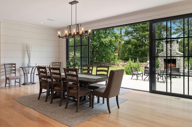 300 Hollow Tree Ridge Rd, Darien, CT 06820 - dining area with a chandelier, wood finished floors, and ornamental molding