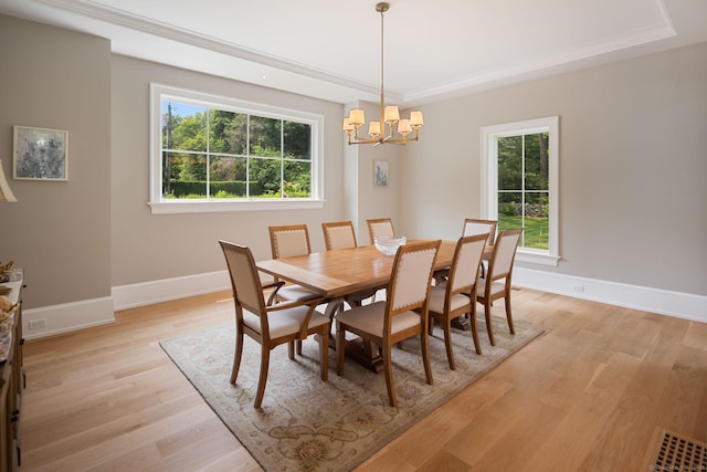 300 Hollow Tree Ridge Rd, Darien, CT 06820 - dining room featuring a raised ceiling, a chandelier, healthy amount of natural light, and light wood-style floors