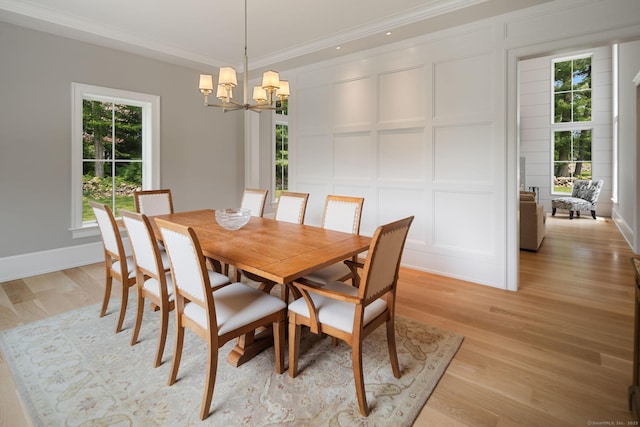 300 Hollow Tree Ridge Rd, Darien, CT 06820 - dining room featuring a decorative wall, a chandelier, crown molding, light wood-type flooring, and baseboards