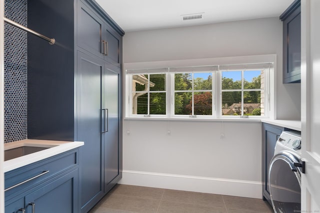 300 Hollow Tree Ridge Rd, Darien, CT 06820 - washroom with cabinet space, washer / dryer, plenty of natural light, and light tile patterned floors