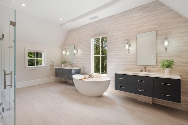 300 Hollow Tree Ridge Rd, Darien, CT 06820 - bathroom with two vanities, a stall shower, plenty of natural light, baseboards, and vaulted ceiling