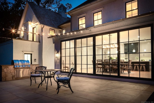300 Hollow Tree Ridge Rd, Darien, CT 06820 - patio at night with a grill and outdoor dining area