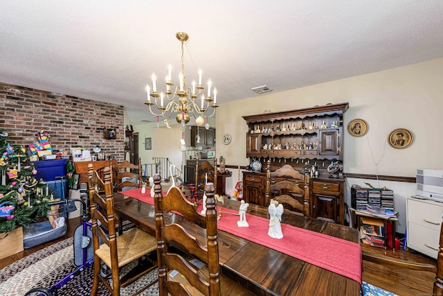 34 Cedar Rock Rd, Woodbridge, CT 06525 - dining area featuring wood finished floors, a chandelier, brick wall, and a textured ceiling