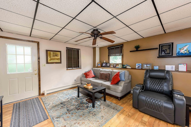 34 Cedar Rock Rd, Woodbridge, CT 06525 - living room featuring a baseboard radiator, ceiling fan, a drop ceiling, and wood finished floors
