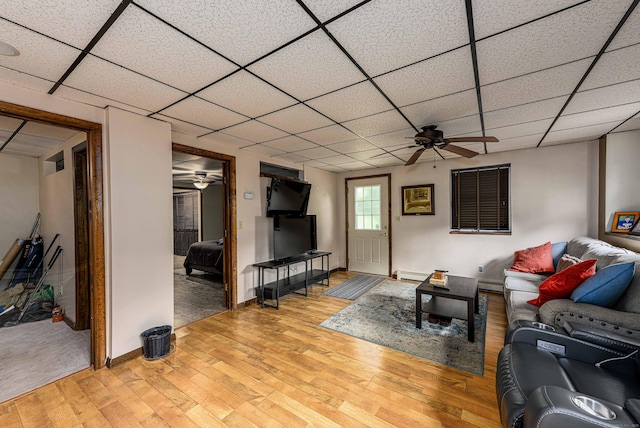 34 Cedar Rock Rd, Woodbridge, CT 06525 - living room with a ceiling fan, a drop ceiling, light wood-style flooring, a baseboard heating unit, and a baseboard radiator