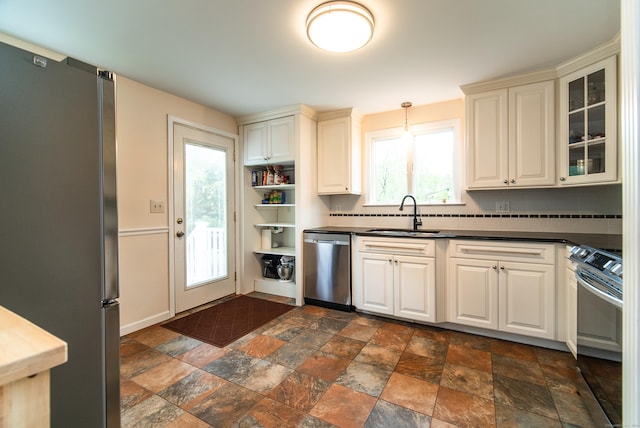 227 Thistle Ln, Southington, CT 06489 - kitchen with stainless steel appliances, dark countertops, a sink, dark stone finish flooring, and glass insert cabinets