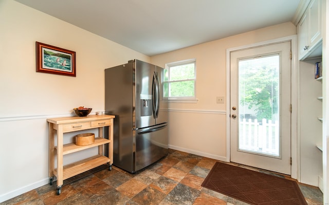 227 Thistle Ln, Southington, CT 06489 - kitchen with stainless steel fridge, dark stone finish floors, and baseboards