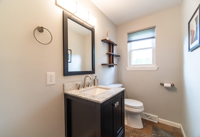 227 Thistle Ln, Southington, CT 06489 - bathroom featuring toilet, baseboards, vanity, and stone finish floors
