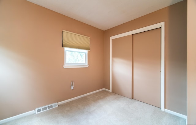 227 Thistle Ln, Southington, CT 06489 - unfurnished bedroom featuring light colored carpet, baseboards, and a closet