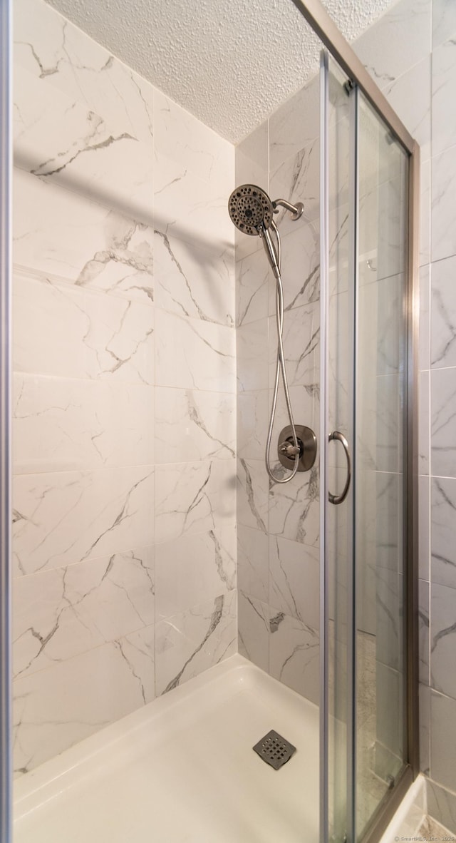 227 Thistle Ln, Southington, CT 06489 - full bathroom featuring a textured ceiling and a marble finish shower