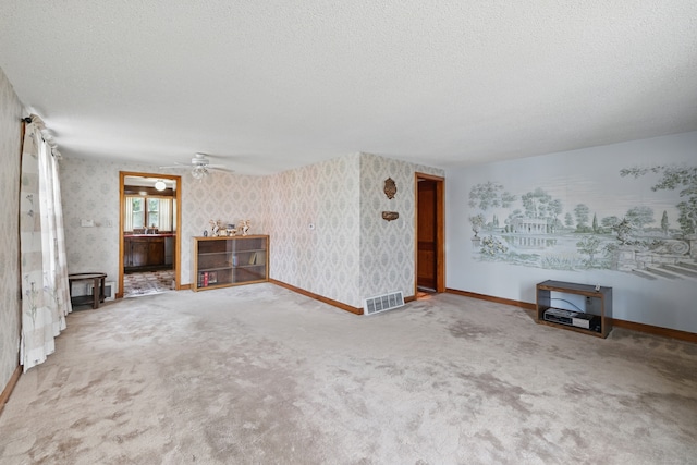 24 Goff St, Waterbury, CT 06704 - unfurnished living room with a textured ceiling, carpet flooring, baseboards, wallpapered walls, and ceiling fan